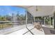 Spacious screened porch with deck and seating area, overlooking lush greenery at 1811 Music Ln, North Port, FL 34286