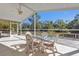 Spacious screened porch with a glass top table and chairs at 1811 Music Ln, North Port, FL 34286