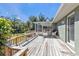 Expansive wooden deck connecting to a screened porch at 1811 Music Ln, North Port, FL 34286