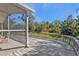 Long wooden deck with screened porch and backyard access at 1811 Music Ln, North Port, FL 34286