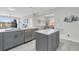 Modern kitchen island with gray cabinets and quartz countertop, stainless steel appliances at 2002 Bal Harbor Blvd # 1312, Punta Gorda, FL 33950