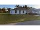 Front view of a newly built home with a grassy lawn at 20399 Ladner Ave, Port Charlotte, FL 33954