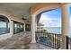 Large balcony with water views, tiled flooring, columns, and ceiling fan at 2102 Palm Tree Dr, Punta Gorda, FL 33950