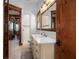 Spacious bathroom with dual vanity sinks, white countertop, light wood cabinets, and wood-framed mirrors at 2102 Palm Tree Dr, Punta Gorda, FL 33950