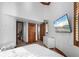 Large bedroom with wood floors, white walls, wood accents, and a TV mounted on the wall at 2102 Palm Tree Dr, Punta Gorda, FL 33950