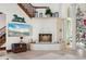 Stone fireplace with decorative metal screen in a bright living room at 2102 Palm Tree Dr, Punta Gorda, FL 33950