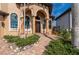 Elegant home entrance with arched doorways, columns, and lush landscaping at 2102 Palm Tree Dr, Punta Gorda, FL 33950