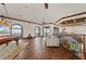 Game room with pool table, seating area, wood floors, and arched windows with water views at 2102 Palm Tree Dr, Punta Gorda, FL 33950