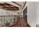 Hallway with wood floor, decorative iron railing, and large glass doors at 2102 Palm Tree Dr, Punta Gorda, FL 33950