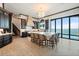 Modern kitchen with dark cabinets, island with seating, and water views at 2102 Palm Tree Dr, Punta Gorda, FL 33950