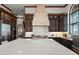 Kitchen island with white countertop, built-in sink, and cooktop at 2102 Palm Tree Dr, Punta Gorda, FL 33950