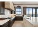 Modern kitchen featuring dark cabinets, white countertops, and stainless steel appliances at 2102 Palm Tree Dr, Punta Gorda, FL 33950