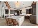 Open concept kitchen with large island, dark wood cabinets, and adjacent dining and living areas at 2102 Palm Tree Dr, Punta Gorda, FL 33950
