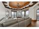 Living area with waterfront views, leather sectional sofa, wood floors, and decorative ceiling at 2102 Palm Tree Dr, Punta Gorda, FL 33950