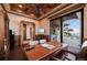 Office with sliding glass doors, a desk, chairs, wood-beamed ceilings, and a view of the pool and water at 2102 Palm Tree Dr, Punta Gorda, FL 33950