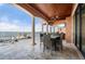 Covered patio with outdoor kitchen, dining area, and waterfront views at 2102 Palm Tree Dr, Punta Gorda, FL 33950