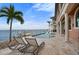 Relaxing pool area with lounge chairs, a waterfront view, and a private dock at 2102 Palm Tree Dr, Punta Gorda, FL 33950