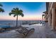 Relaxing pool area with waterfront views, palm trees, and lounge chairs at 2102 Palm Tree Dr, Punta Gorda, FL 33950