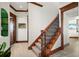 Wooden staircase with wrought iron railing in a hallway at 2102 Palm Tree Dr, Punta Gorda, FL 33950