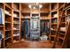 Large walk-in closet with wood shelving, hanging rods, and a ladder at 2102 Palm Tree Dr, Punta Gorda, FL 33950