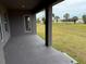 A covered back patio overlooks a grassy yard at 233 W Pine Valley Ln, Rotonda West, FL 33947
