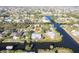 An aerial shot showing a house nestled on a waterway, offering water access and neighborhood context at 3004 Banyan Way, Punta Gorda, FL 33950
