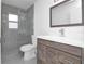 Modern bathroom with a walk-in shower, floating vanity, and stylish mirror at 3004 Banyan Way, Punta Gorda, FL 33950