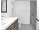 Updated bathroom with a wood vanity, white sink, and a frameless glass shower at 3004 Banyan Way, Punta Gorda, FL 33950