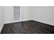 Simple bedroom with dark grey flooring and window with cellular shades at 3004 Banyan Way, Punta Gorda, FL 33950