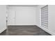 Simple bedroom with dark grey flooring and a door to another room at 3004 Banyan Way, Punta Gorda, FL 33950
