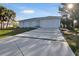 Light blue single-story home with a modern design and landscaped yard at 3004 Banyan Way, Punta Gorda, FL 33950