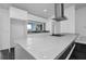 Modern kitchen with white cabinets and white quartz countertops at 3004 Banyan Way, Punta Gorda, FL 33950