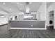 Modern kitchen with gray island, white cabinets, and stainless steel appliances at 3004 Banyan Way, Punta Gorda, FL 33950