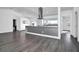 Modern kitchen with gray island, white cabinets, and stainless steel appliances at 3004 Banyan Way, Punta Gorda, FL 33950