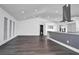 Modern kitchen with gray island, white cabinets, and stainless steel appliances at 3004 Banyan Way, Punta Gorda, FL 33950