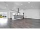 Open living room with modern kitchen, high ceilings, and grey flooring at 3004 Banyan Way, Punta Gorda, FL 33950