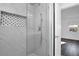 Clean and modern shower with marble tile and hexagon mosaic accents at 3004 Banyan Way, Punta Gorda, FL 33950