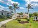 Elevated view of a single-story home with a circular driveway and tropical landscaping at 3310 Tripoli Blvd, Punta Gorda, FL 33950