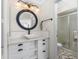 Modern bathroom featuring a stylish vessel sink, circular mirror, and white vanity at 3310 Tripoli Blvd, Punta Gorda, FL 33950