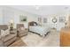 Relaxing bedroom with comfortable seating area, wood-look flooring, and ensuite bathroom access at 3310 Tripoli Blvd, Punta Gorda, FL 33950