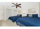 Second bedroom with two comfortable beds, ceiling fan, and ample closet space at 3310 Tripoli Blvd, Punta Gorda, FL 33950