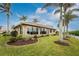 Home exterior with lush landscaping, palm trees, and water views at 3310 Tripoli Blvd, Punta Gorda, FL 33950