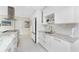 Modern kitchen featuring white cabinets, granite countertops, and stainless steel appliances at 3310 Tripoli Blvd, Punta Gorda, FL 33950