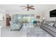 Living room with plush seating, ceiling fan, and a view of the water through sliding glass doors at 3310 Tripoli Blvd, Punta Gorda, FL 33950