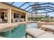 Spacious pool area with attached spa and outdoor seating at 3443 Kentia Palm Ct, North Port, FL 34288