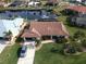 Aerial view of single-Gathering home with canal access, boat, and lush landscaping at 3448 Nighthawk Ct, Punta Gorda, FL 33950