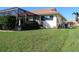 Large grassy backyard with pool and cabana at 3448 Nighthawk Ct, Punta Gorda, FL 33950