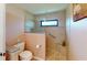 Walk-in shower with tiled walls and pebble flooring at 3448 Nighthawk Ct, Punta Gorda, FL 33950