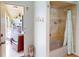 Bathroom with shower, tub, and access to the outdoor patio at 3448 Nighthawk Ct, Punta Gorda, FL 33950