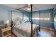 Bedroom with a four-poster bed and ceiling fan at 3448 Nighthawk Ct, Punta Gorda, FL 33950